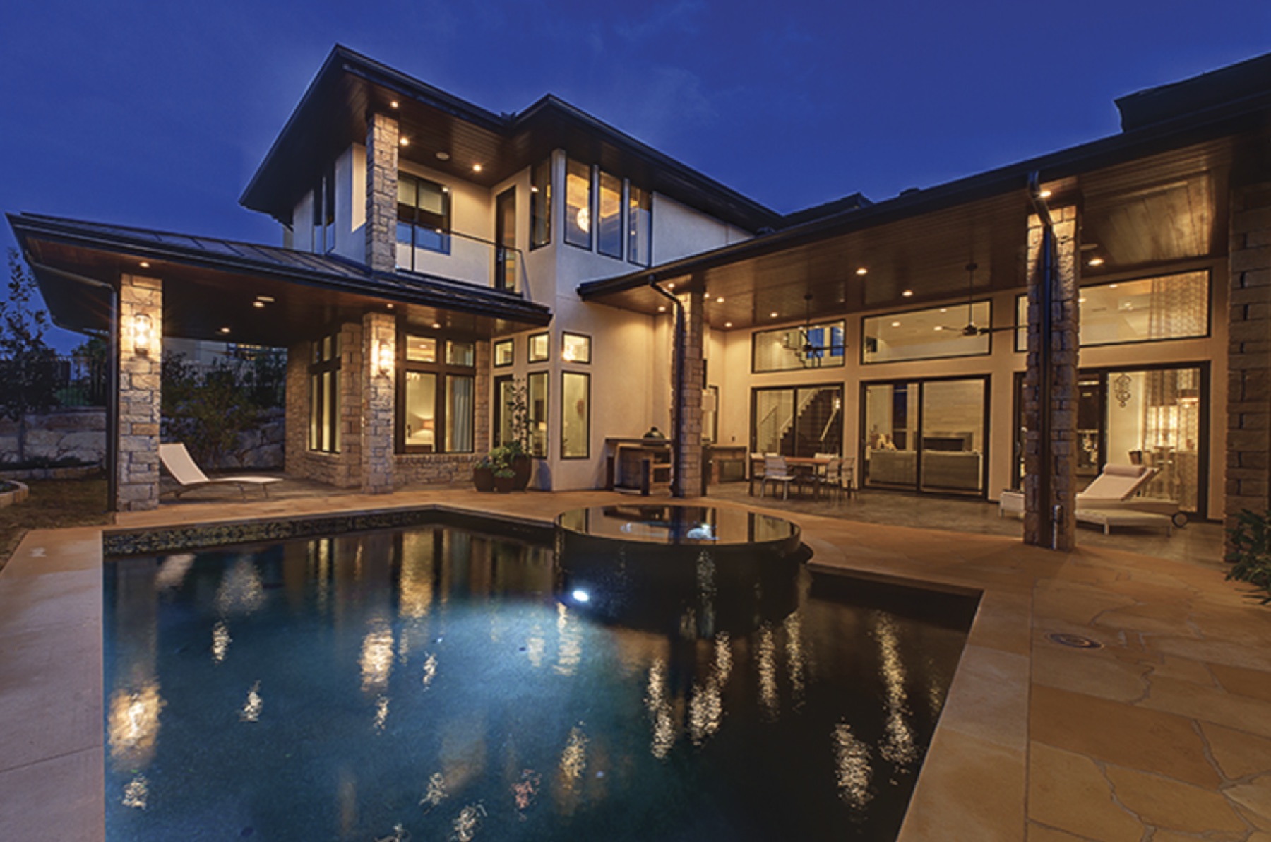 Rear elevation at twilight with pool and spa
